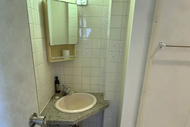 リゾートバイトの個室寮にある洗面台と鏡。白を基調とした清潔感のある設備の画像。