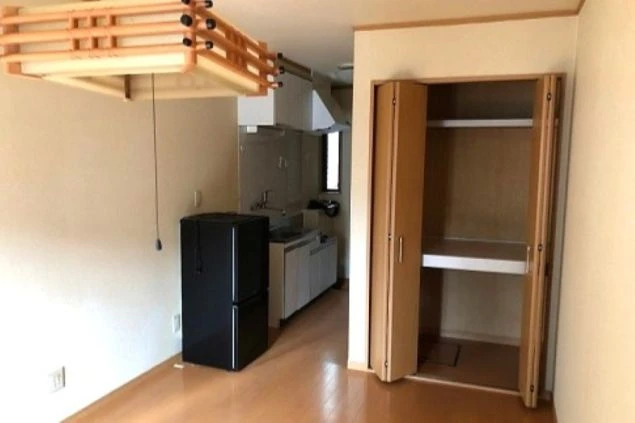 西伊豆でリゾートバイトするスタッフが住む寮の画像。押し入れがあり、キッチンや冷蔵庫も見える。