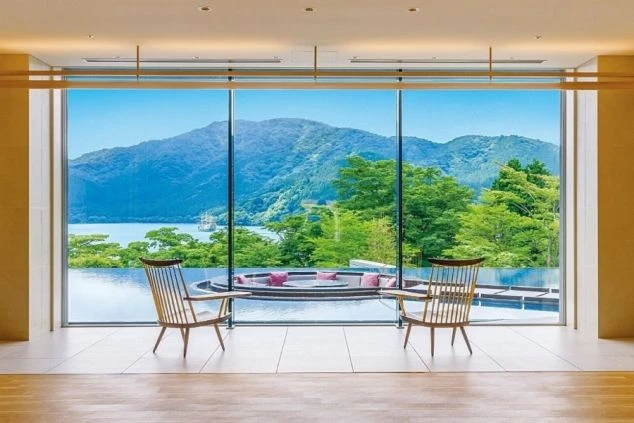 大きな窓から芦ノ湖と雄大な山々が見える高級リゾートホテルのラウンジ。