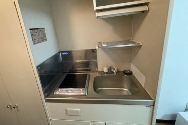 IHコンロ付きのミニキッチン。自炊に便利なリゾートバイト寮の設備。