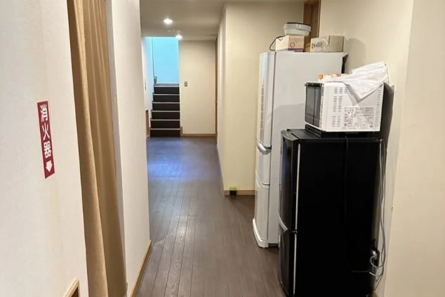 リゾートバイトの寮の廊下に置かれた冷蔵庫の画像。