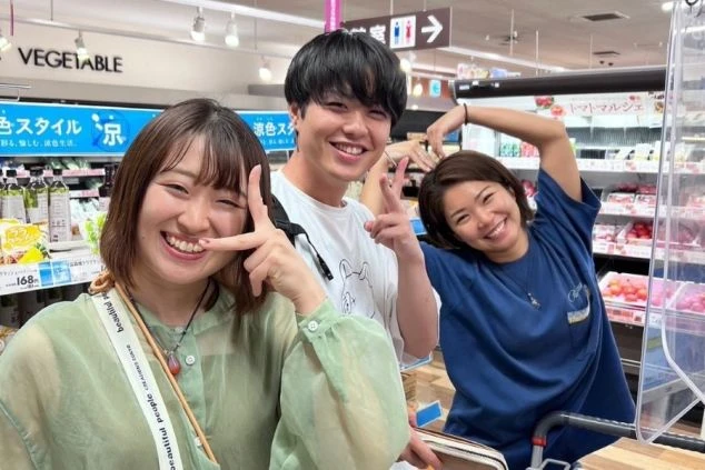 スーパーマーケットのような店内で、楽しそうに笑顔を見せる3人の若い男女の画像。リゾートバイト中の日常生活や、仲間との交流の楽しさを表すイメージ。
