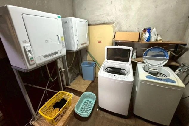 リゾートバイト寮の洗濯・乾燥機。冬場の洗濯もスムーズにできる便利な共用設備で、長期滞在も快適。