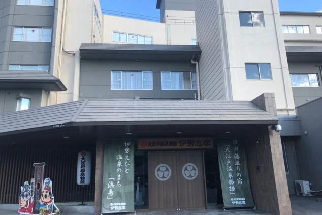 グレーとベージュの外壁を持つ大きな建物の全景。