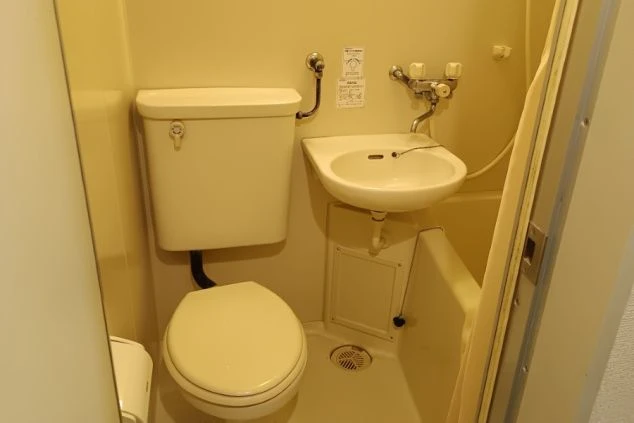 リゾートバイト寮の個室内にある3点ユニットバスの画像。トイレ、洗面台、お風呂が一体となったコンパクトで清潔な水回り設備。