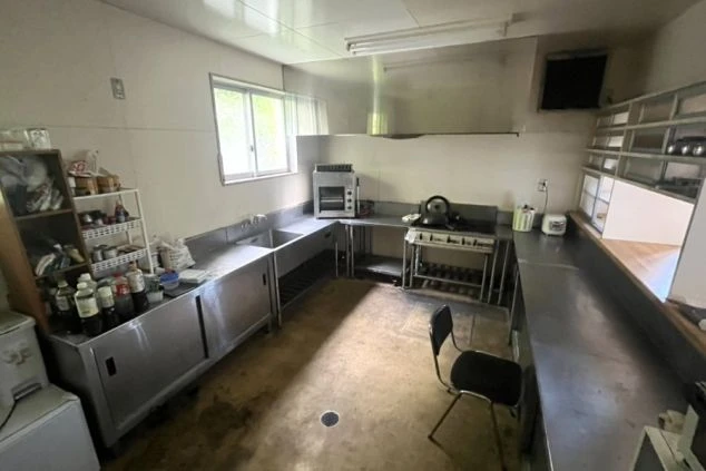 調味料や炊飯器などの家電が並ぶ共用キッチンの画像。