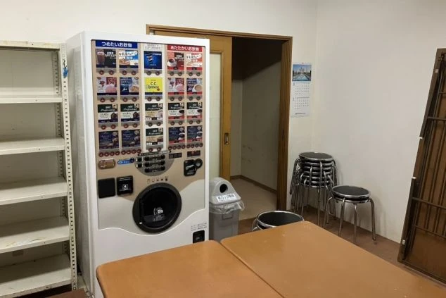 リゾートバイトの男性寮の共用休憩スペース。テーブルや椅子のほか、いつでも飲み物が買える自動販売機が設置されている。