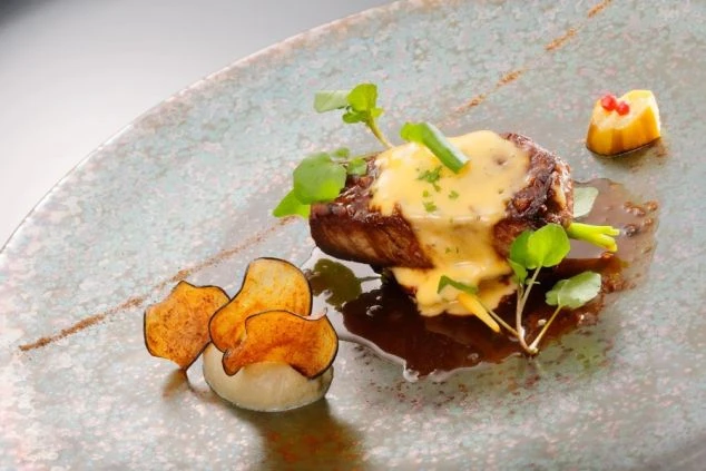 盛り付けが美しい豪華な料理。レストランでの調理や配膳の仕事がイメージできる。