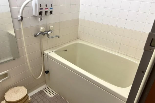 リゾートバイトの社員寮の部屋を表現するイメージ画像。浴槽とシャワーが備え付けられた独立風呂。