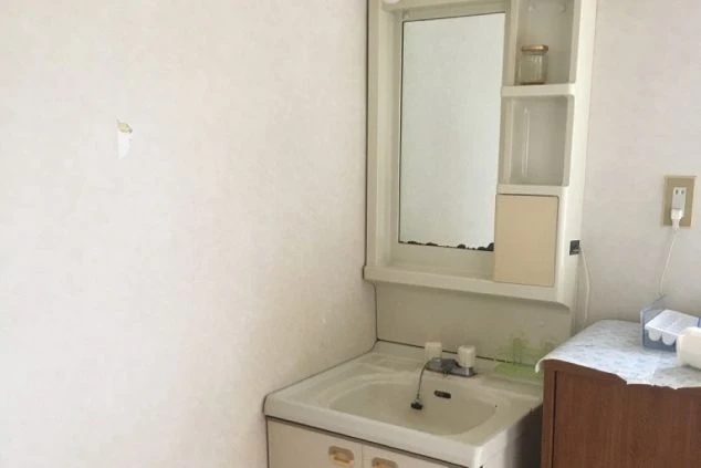 リゾートバイトの寮に備え付けられた洗面台。鏡付きの棚があり、日用品を置くスペースも確保されています。
