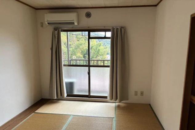 リゾートバイトの個室寮の室内。畳の床で、エアコンが設置されている。