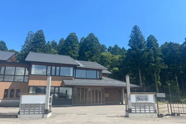 雪景色の中で湯気立つ露天風呂。雪をかぶった山や木々が見え、冬のリゾートバイトで、仕事の後に雪見風呂を楽しめることをアピール。