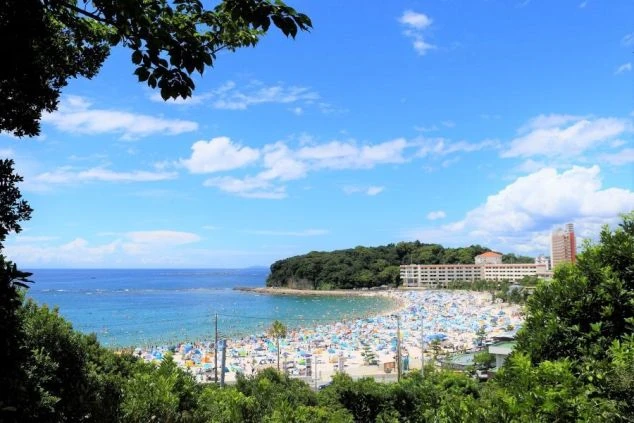 青い海と青い空の下に広がる南紀白浜の賑やかなビーチ。