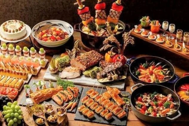 リゾートホテルで提供される豪華なビュッフェ料理。肉やデザートなど品数が豊富。レストランでのリゾートバイトの仕事内容や、まかないのイメージ。