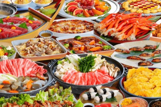 ズワイガニ、刺身、肉料理、鍋物、寿司、デザートなど、豪華な和洋折衷のビュッフェ料理が並ぶ画像。リゾートバイトのまかないやレストランで提供される料理を表す画像。