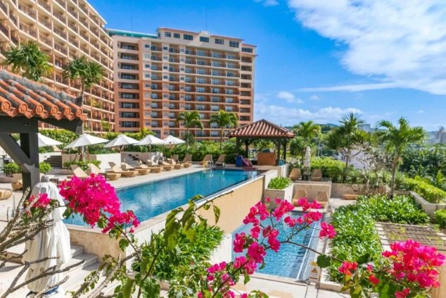 青い空と花々が美しい、南国リゾートホテルのプール。リゾートバイトの休日には、プールでのんびりリフレッシュできます。