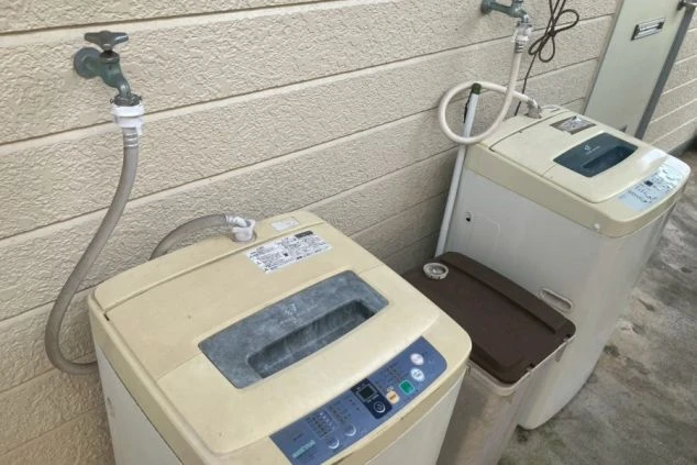 リゾートバイトの寮の共同洗濯機。屋外に複数台設置されており、無料で洗濯ができる設備。