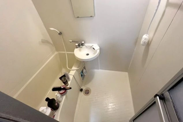 リゾートバイトの寮のユニットバス。シャワー付きの浴槽と洗面台が一体になった清潔な浴室。