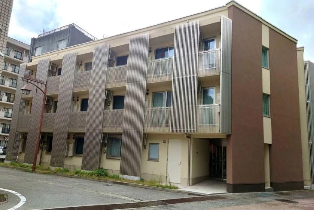 女性寮の外観。ブラウンとベージュでモダンなデザインのマンション。